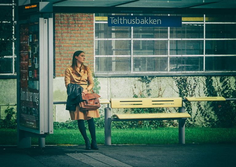 Woman waiting at Telthusbakken bus stop in Oslo