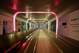 Empty hallway leading down to a platform at Oslo S